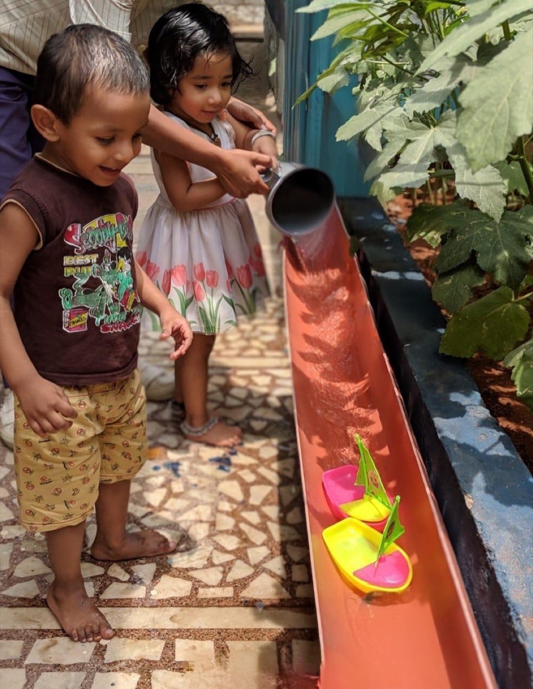Children playing at the boat passage water station